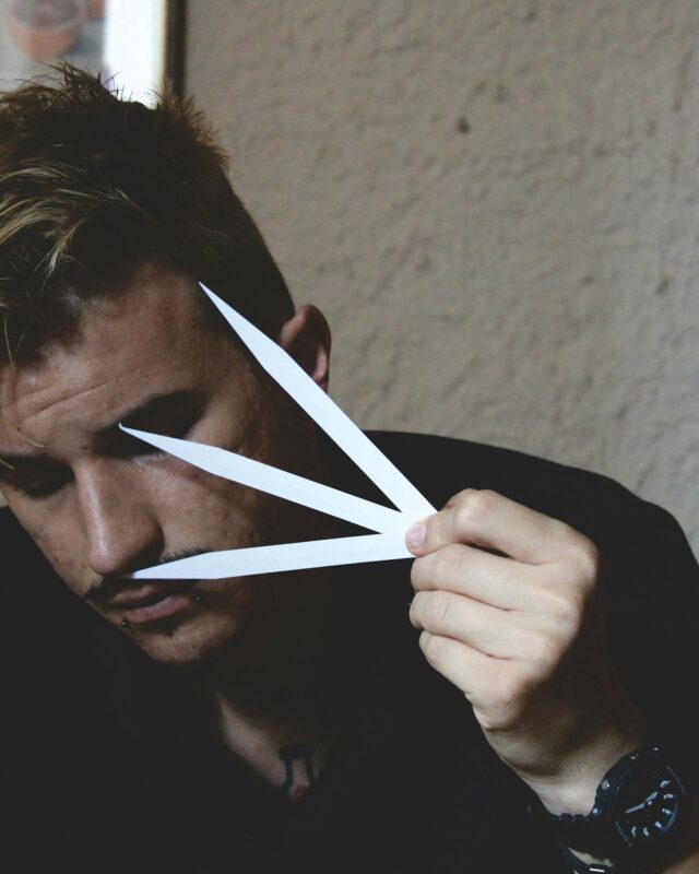 A perfumer assessing a scent on a paper blotter