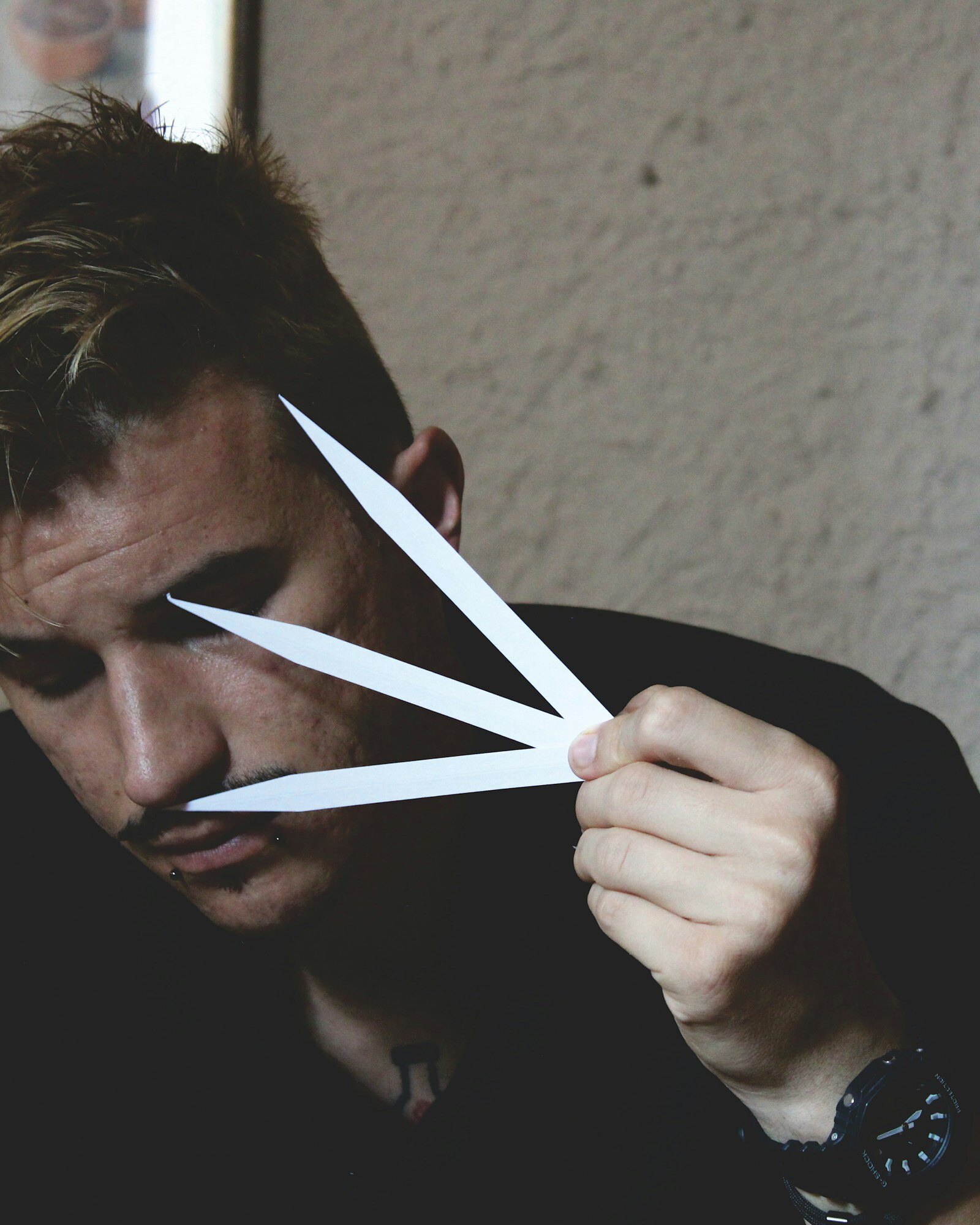 A perfumer assessing a scent on a paper blotter