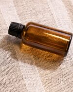 Nefer Eau de Parfum resting on woven linen
