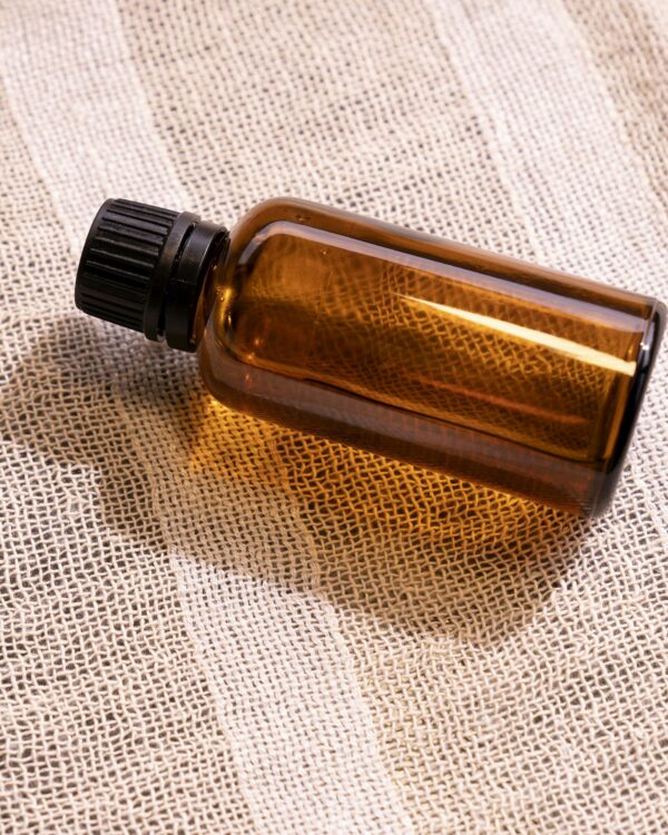 Nefer Eau de Parfum resting on woven linen