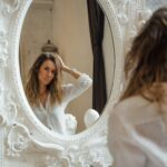 A mirror photograph of a relaxed white shirt worn at home
